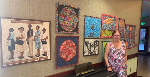 A resident with her art quilts.